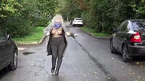 Sexy blonde milf walks outdoors in transparent nylon, flaunting her big boobs and ass