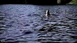 Blonde girl in bikini swims in supernatural setting