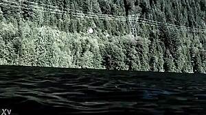 Beautiful blonde swims in the lake and shows her charms