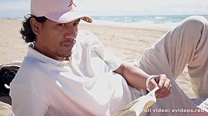 a boy relaxes reading on the beach but she surprises him