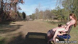 Big boobed lesbians try out strap on dildo during a picnic in the park