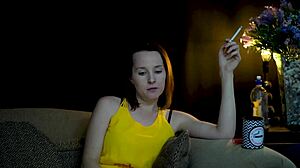A brunette seductress sucks on a cigarette while she watches you
