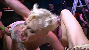 A tattooed slut enjoys a golden shower