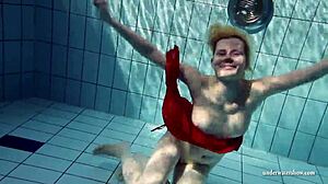 Young Russian girl Lucie swims in the pool