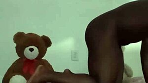 Enjoying a threesome with brown and caucasian furry toy bears during foreplay and massage