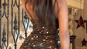 Pretty Asian girl in a sexy dress poses alone