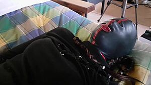 Blindfolded and bound, she pleases her masked partner