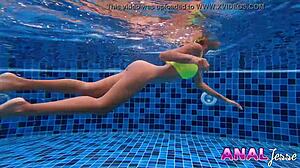 I watch this asian girl swim with her big butt plug