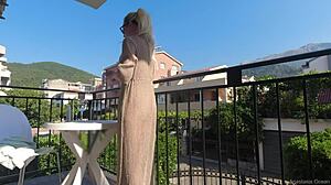Topless beauty enjoys the outdoors on her balcony