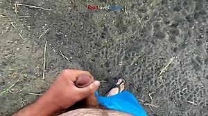 A brunette masturbates solo under a bridge in hentai style.