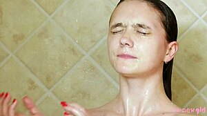 Beautiful brunette model bathing in the shower