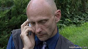A man with a shaved head has a young wife and he is watching her get fucked by another man outside