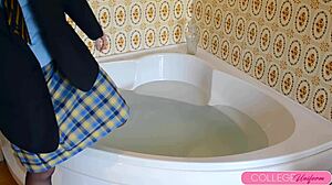 Clothed girlfriend enjoys a wet and wild time in the tub