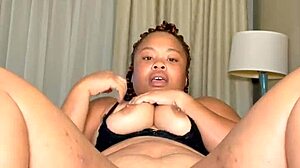 Big breasted black MILF masturbates with a toy and has a squirting orgasm