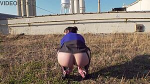 Beautiful woman showing her curves and tempting her ass on the loading dock