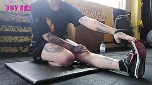 Alternative looking woman stretching in the gym