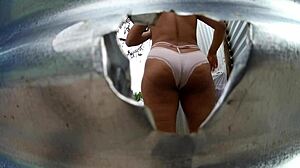 A woman was changing at the beach, unaware