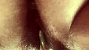 A close-up view of a girl masturbating with a glass toy