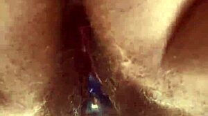 A close-up view of a girl masturbating with a glass toy