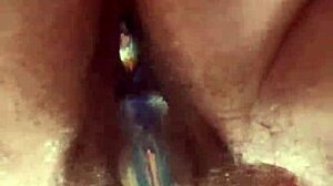 A close-up view of a girl masturbating with a glass toy
