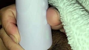 The girl plays with a toy in her wet pussy during masturbation