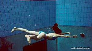 Martina in a blue bikini underwater, tightening her pussy