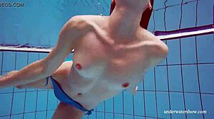 Martina in a blue bikini underwater, tightening her pussy