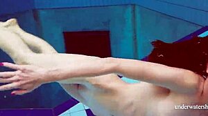 Martina in a blue bikini underwater, tightening her pussy