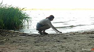 Beside the lake, teen redhead Mia fingers her shaved pussy to a wild orgasm.