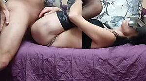 Busty wife enjoys intimate moments in black stockings and lingerie