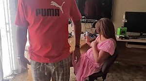 The brunette amateur plays with his cock in her dress at home, teasing with natural tits.