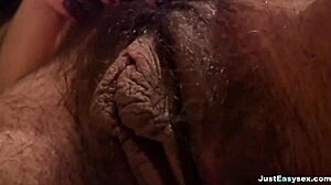 busty babe fingers her hairy pussy in the bathroom