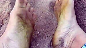 Bare feet sinking into warm beach sand