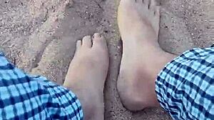Bare feet sinking into warm beach sand