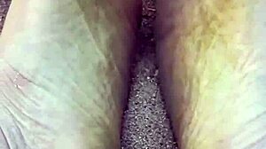 Bare feet sinking into warm beach sand