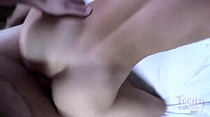 A beautiful young woman with curly hair enjoys a relaxing evening in bed