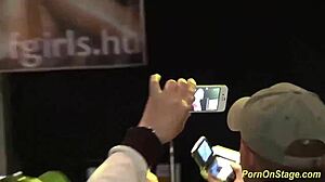 Cock sharing unfolds in wild public stage performance