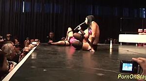 Cock sharing unfolds in wild public stage performance