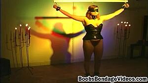 Pale redhead's big tits bound by ruthless master