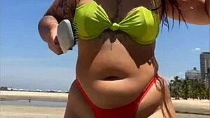 African Wife Flashes Stuffed Bikini On Beach