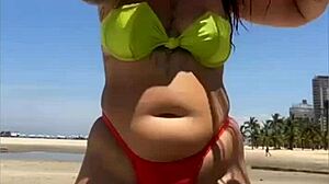 African Wife Flashes Stuffed Bikini On Beach