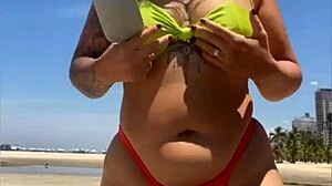 African Wife Flashes Stuffed Bikini On Beach