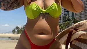 African Wife Flashes Stuffed Bikini On Beach