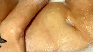 What does this horny British slut do in the shower alone?