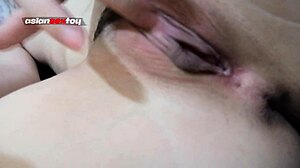 asian teen pleases her horny tight pussy with a small candle in close up