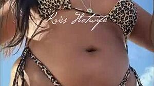 hey, check this married slut showing off her big ass in a tiny bikini at the beach?