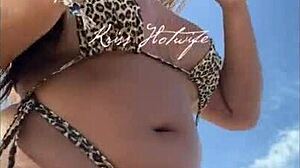 hey, check this married slut showing off her big ass in a tiny bikini at the beach?