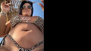 hey, check this married slut showing off her big ass in a tiny bikini at the beach?