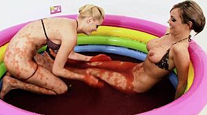 Chloe Conrad and Leila Bee intensely masturbate in strawberry jelly pool