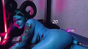 Hey, watch this tattooed blue slut with huge tits ride a machine!